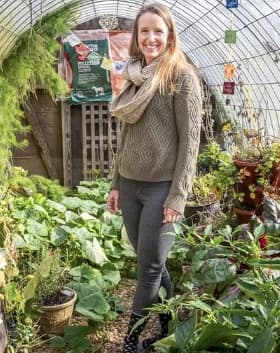 jenn mcconnell in a greenhouse surrounded by plants at the yoga hive in manahawkin, nj