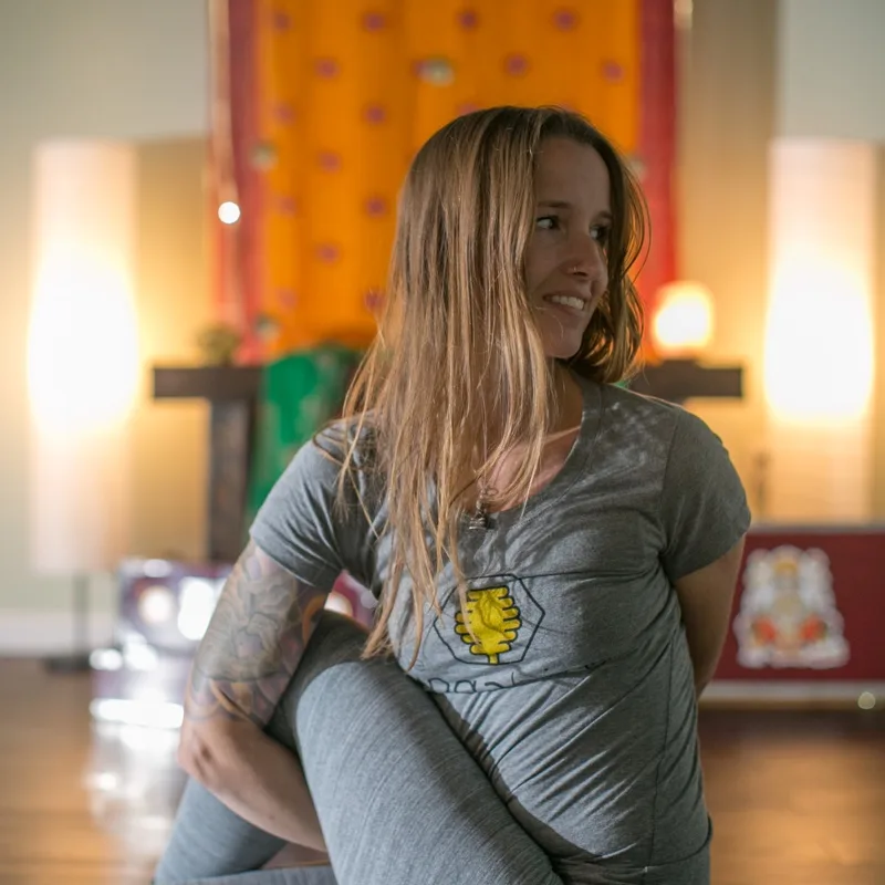 jenn demonstrating a seated twist during a 300-hour teacher training session at the yoga hive in manahawkin, nj