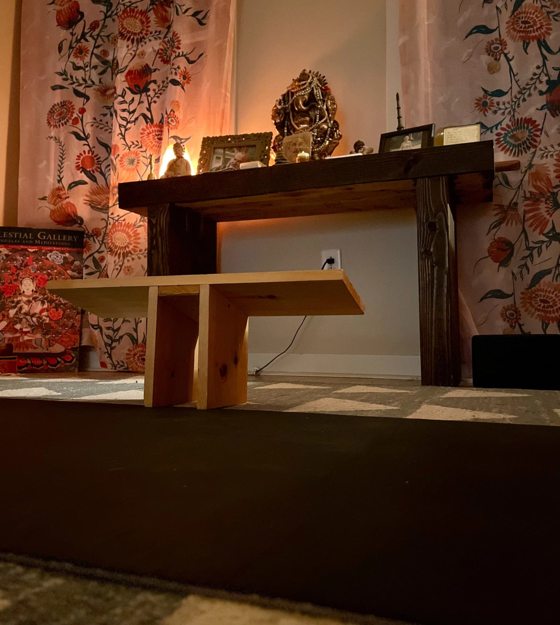 the warm studio altar at the yoga hive, with candles, statues, and floral hangings in manahawkin, nj